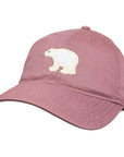 A dusty rose pink baseball cap featuring an embroidered white polar bear patch on the front, set against a plain white background.