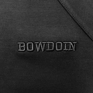 Closeup photo of raised black on black Bowdoin embroidery.