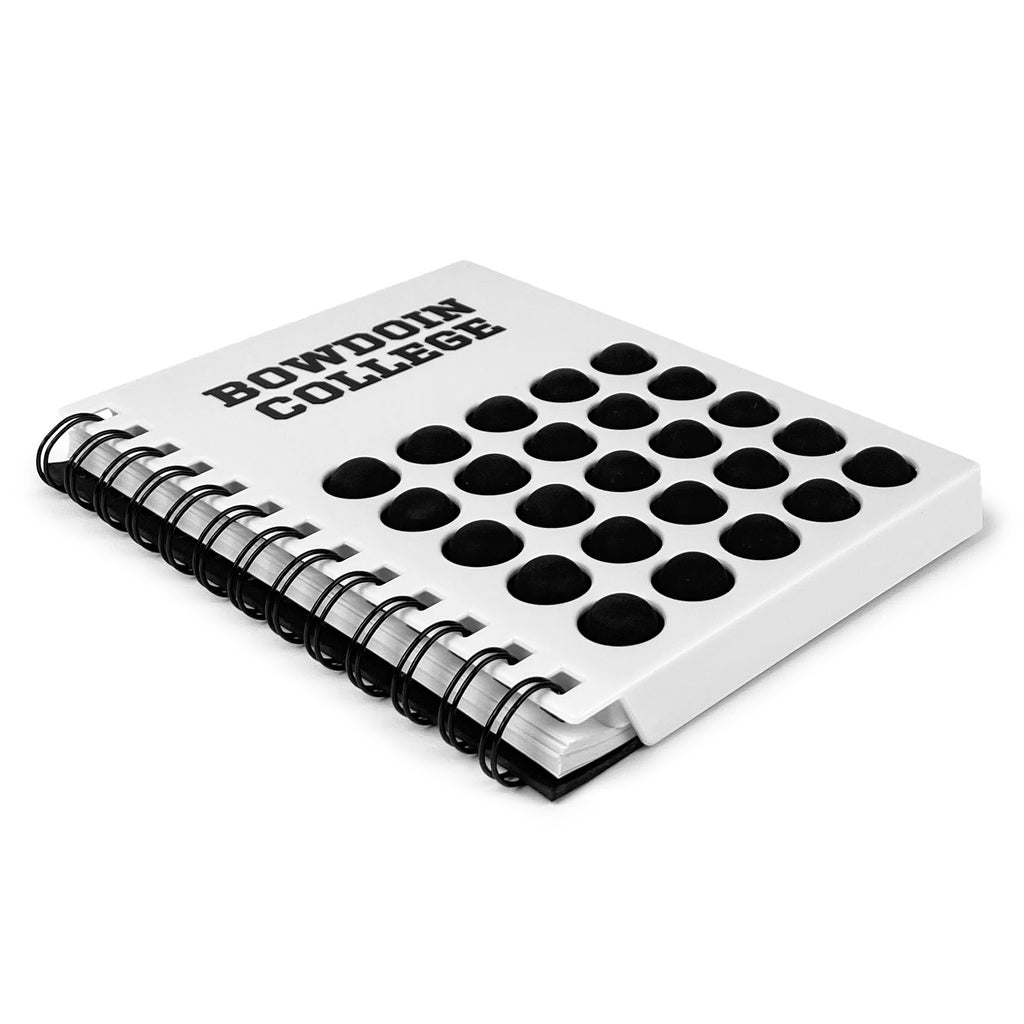 Small notebook with white plastic cover and black silicone push pop stress reliever. BOWDOIN COLLEGE imprint across the top.