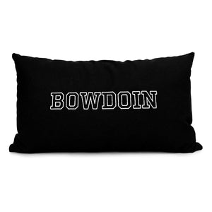 Black lumbar pillow with embroidered BOWDOIN in white outline.