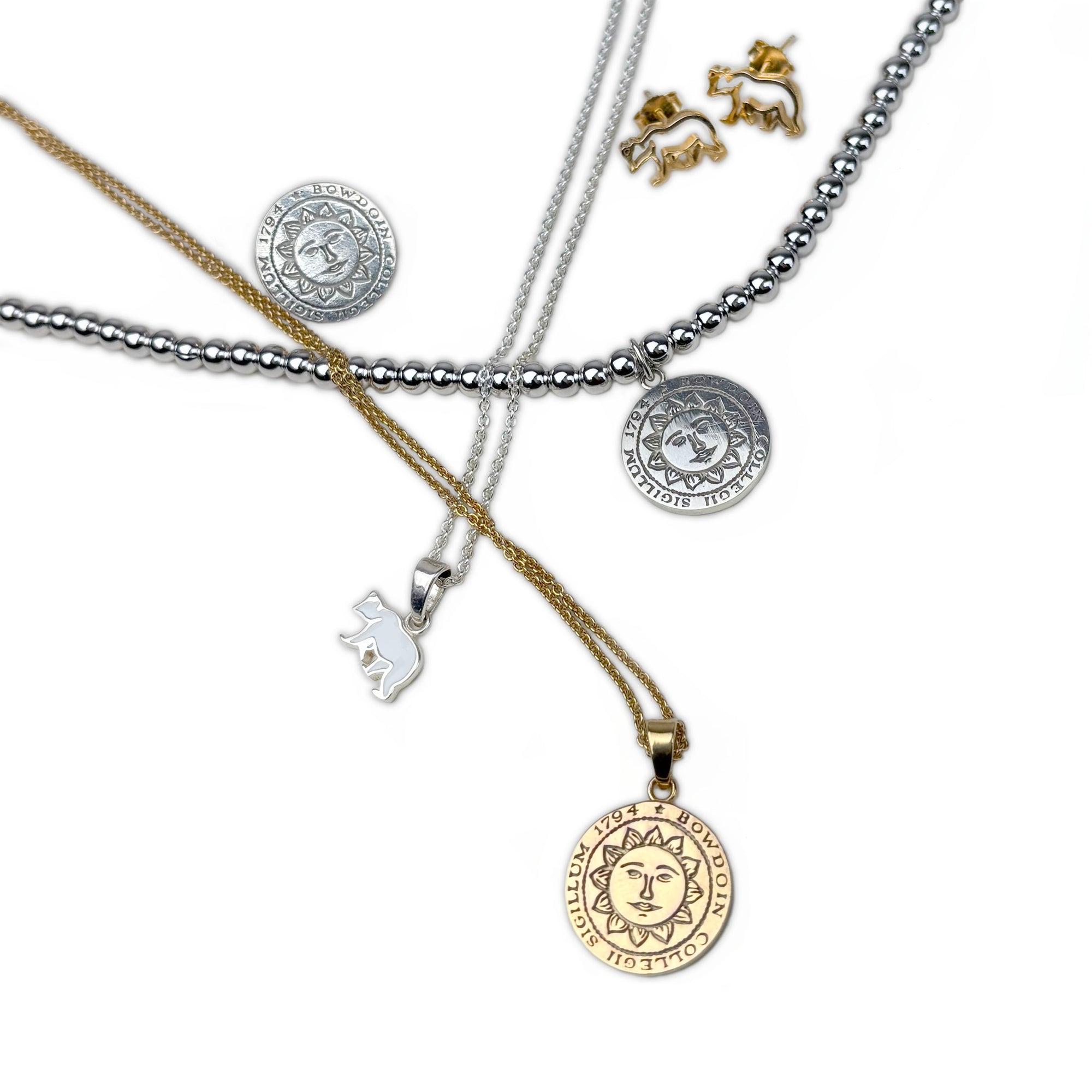 Collection of necklaces with various pendants on a white background