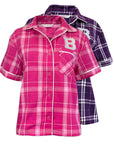 Two short-sleeve plaid button-up shirts shown on a white background, with a pink shirt in front and a purple shirt behind it. Both shirts feature a large letter 'B' on the chest and white piping along the collar, placket, and sleeve cuffs.