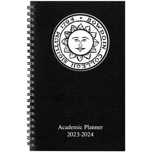 Black day planner with white Bowdoin sun seal imprint