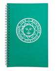 A teal green spiral-bound notebook with a white printed circular seal featuring a sun face and the text 'BOWDOIN COLLEGII SIGILLUM 1794' on the cover, shown on a plain white background.