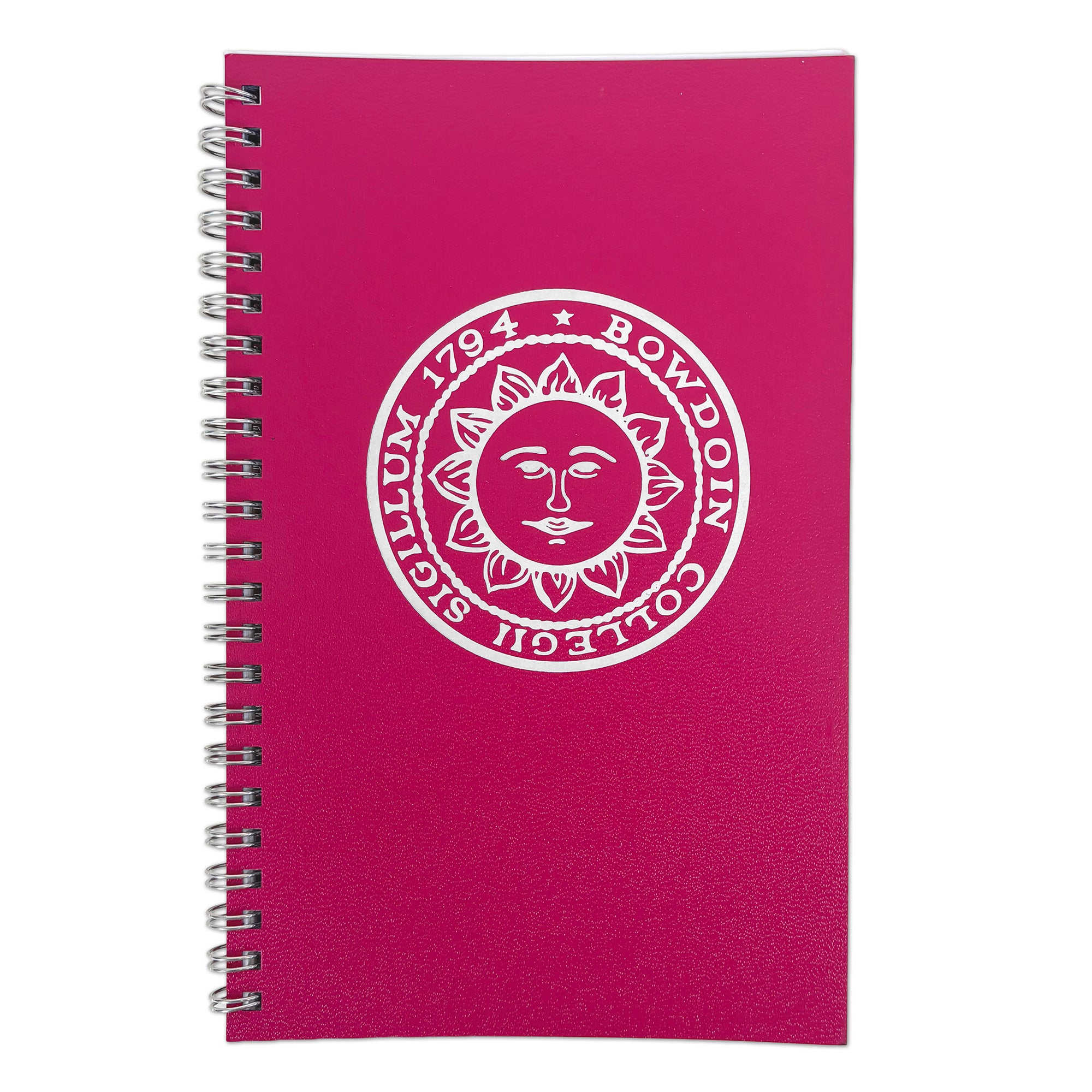 A pink spiral-bound notebook with a white printed circular emblem featuring a sun face and the text BOWDOIN COLLEGII SIGILLUM 1794', shown on a plain white background.