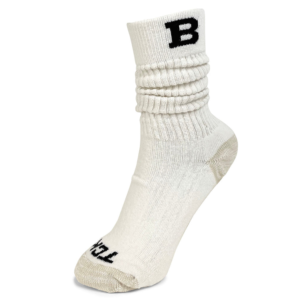 Cream colored slouch crew sock with beige toe and heel. Black TCK knit in on toe, black B on cuff.