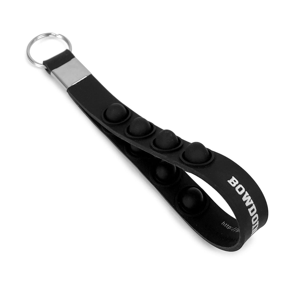 Black fidget popping silicone key tag with white BOWDOIN COLLEGE imprint.