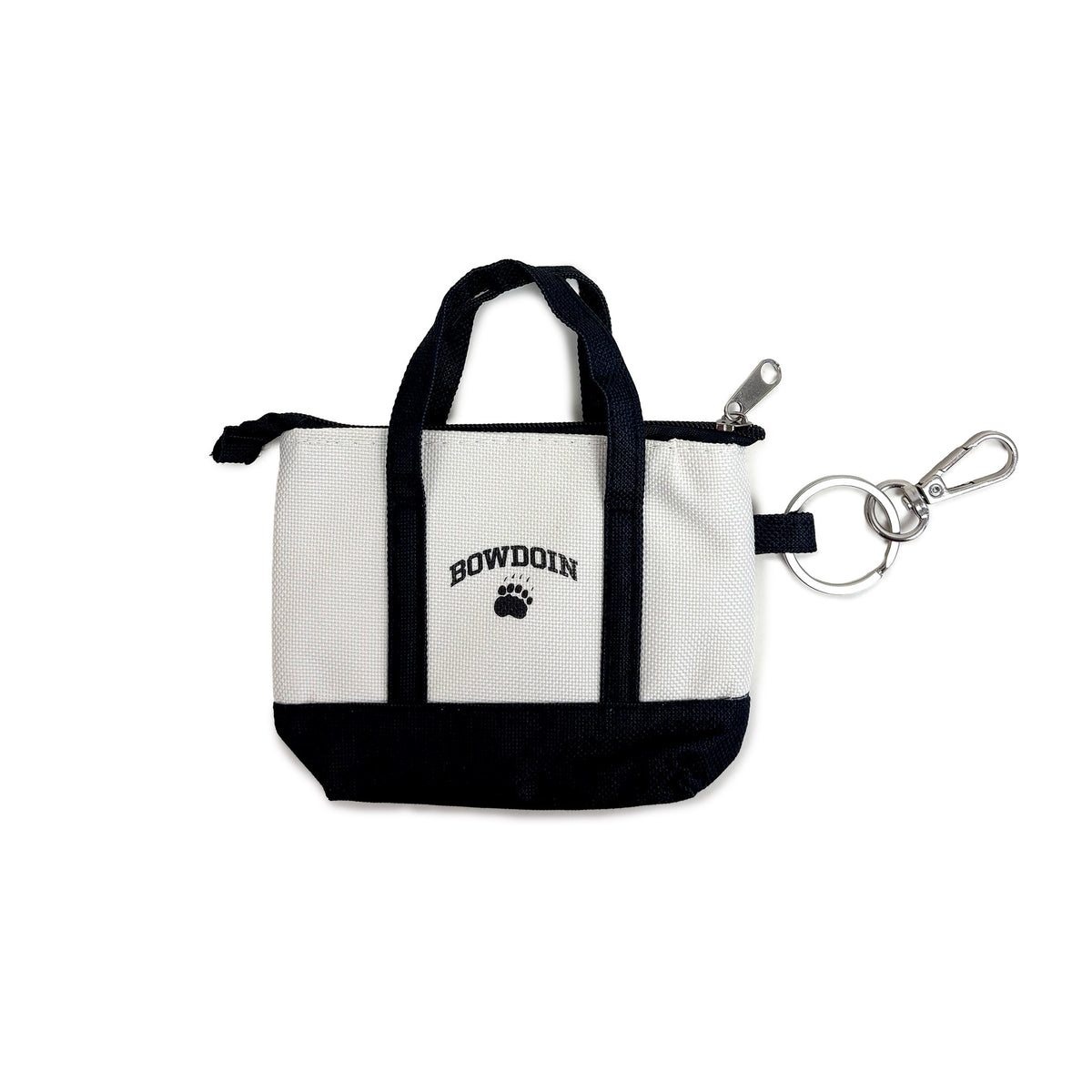 A small zippered tote bag with a white canvas body, black handles and bottom trim, and a black 'BOWDOIN' and paw print logo on the front. It is shown with a silver clip on a plain white background.