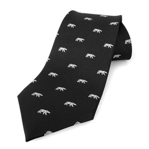 Rolled up black necktie with white all-over woven imprint of polar bears in profile.