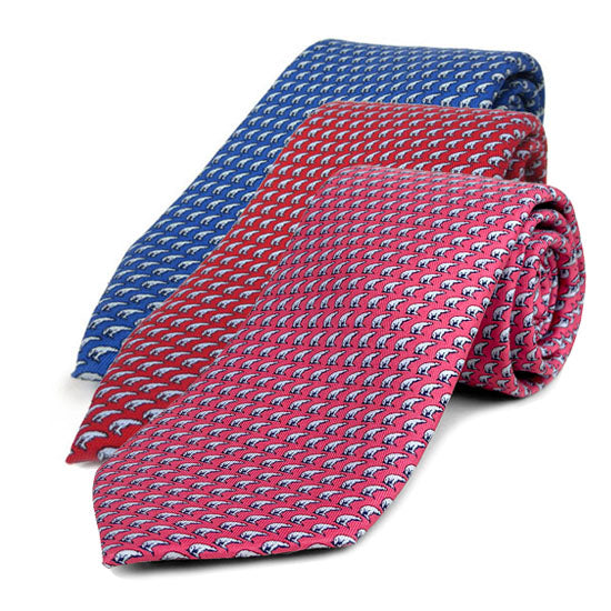 Three patterned ties, blue, red, and pink, on a white background