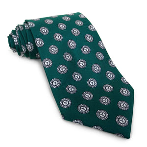 Spruce green necktie with repeating all-over Bowdoin College sun seal design.