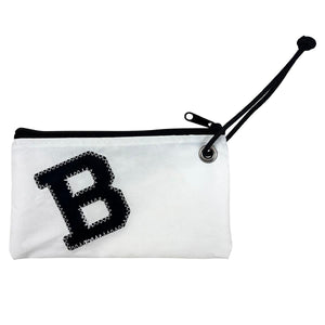 White rectangular bag with steel grommet in right side laced with black carrying cord. Black zipper and black B applique with white stitching.