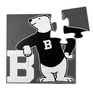 12-piece square jigsaw puzzle with picture of cartoon polar bear wearing a black sweater and leaning on a large letter B.