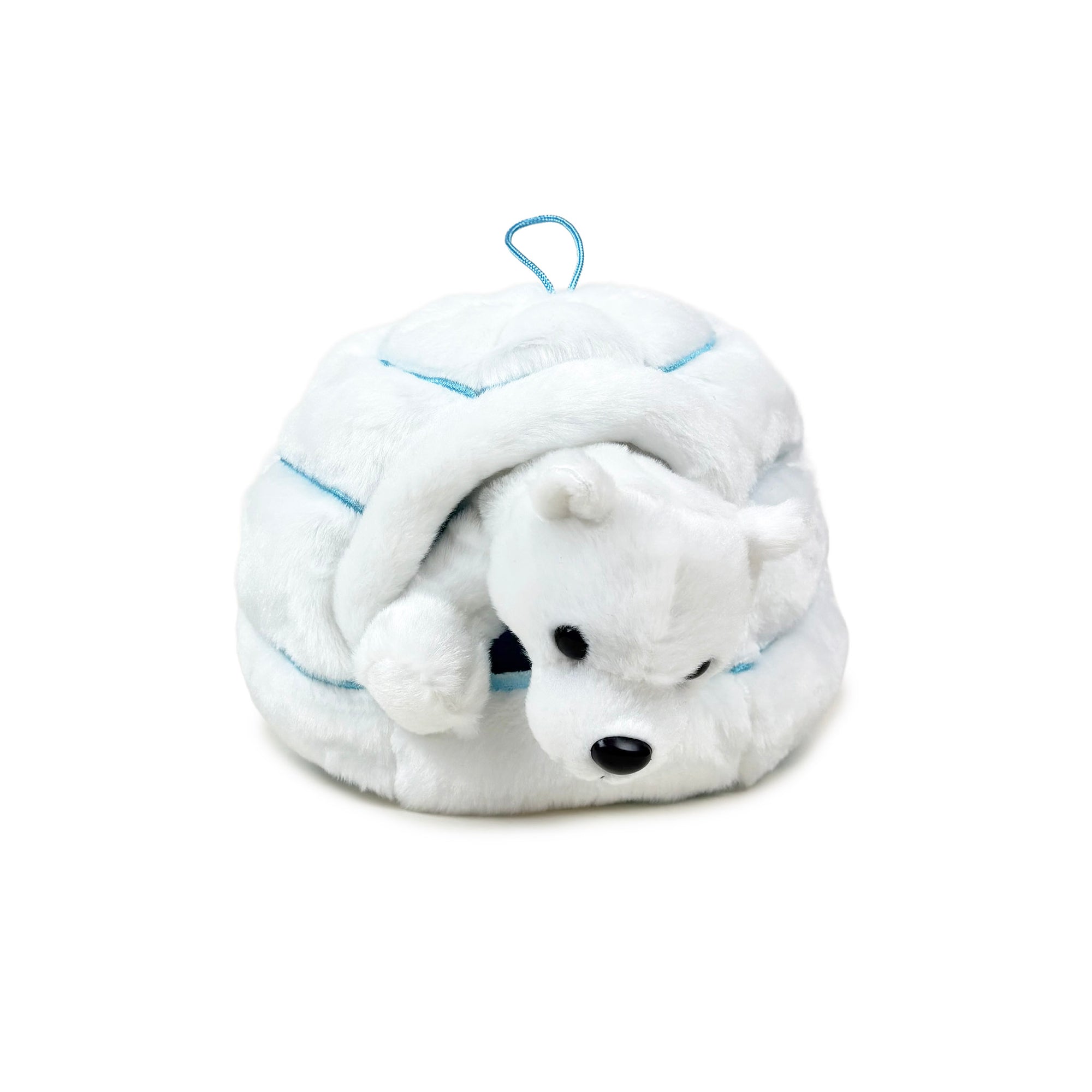 Plush polar bear toy in a plush igloo with a blue tag on a white background
