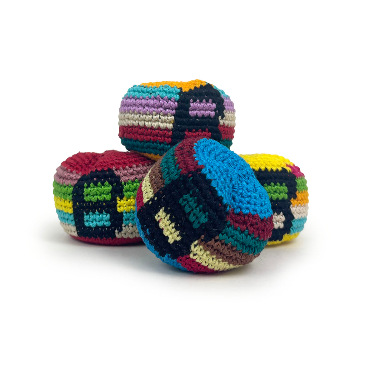 Four colorful crocheted footbag toys arranged together on a clean white background.