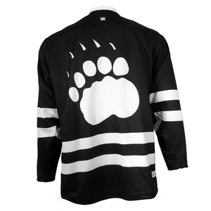 Back view of hockey jersey showing sublimated white paw print imprint on back, above double white stripe.