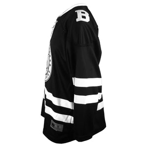 Side view of hockey jersey, showing white Bowdoin B embroidered on shoulder.