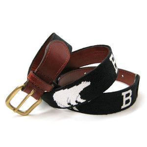 A brown leather belt with a needlepointed design of white Bs and white polar bears on a black field.