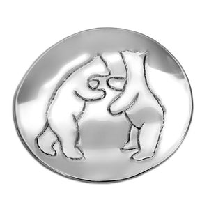 Roughly round aluminum plate with simple engraving of two polar bears standing and facing each other.