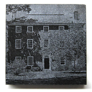 Square black granite coaster with etched Mass Hall.