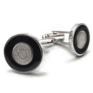 Silvertone cufflinks with black enamel around small engraved Bowdoin seal medallion.