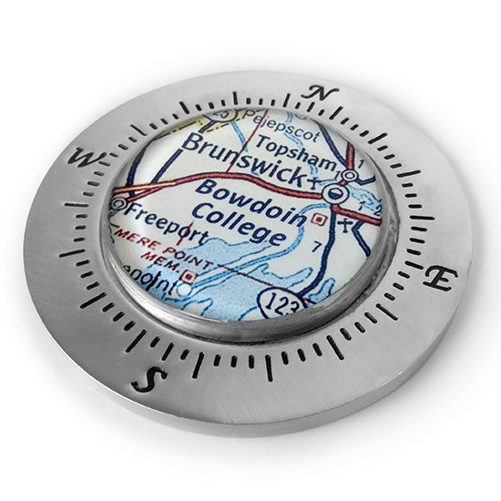 Pewter compass rose-style paperweight with large cabochon in the center over a map of Midcoast Maine.