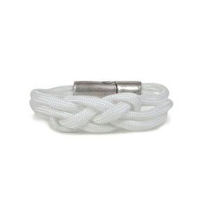 Bracelet made of white cord, tied in a single carrick knot.