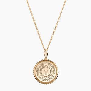 Small round pendant necklace with Bowdoin sun seal engraving, surrounded by sunburst edging.