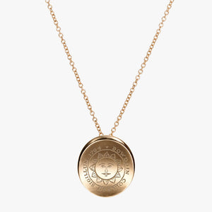 Gold necklace with slightly concave gold pendant engraved with the Bowdoin College seal.