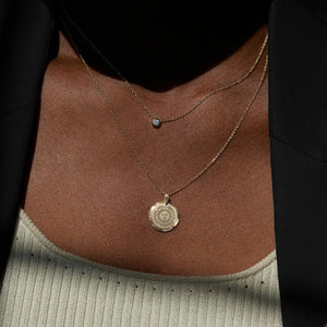 Black woman wearing a Bowdoin 7-point Diamond necklace.