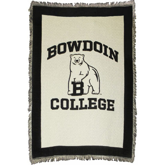 Ivory tapestry throw with fringe and black border. Black woven imprint of BOWDOIN arched over polar bear mascot over COLLEGE.