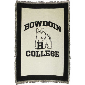 Ivory tapestry throw with fringe and black border. Black woven imprint of BOWDOIN arched over polar bear mascot over COLLEGE.