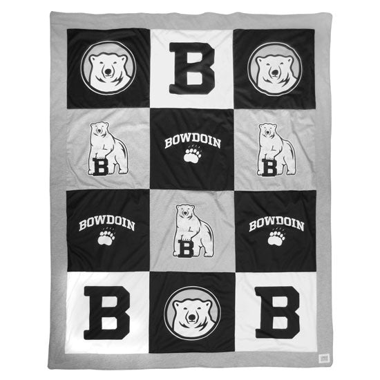 Large quilt with grey trim and panels in black, white, and grey, with Bowdoin imprints on each.