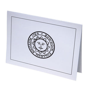 White notecard with sun seal on front.