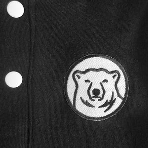 Closeup of embroidered polar bear medallion patch.