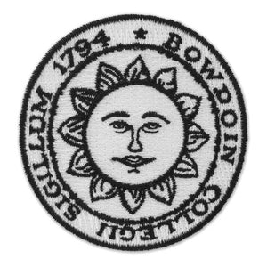 Black and white embroidered Bowdoin sun seal patch.