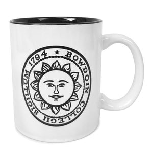 White coffee mug with black interior and Bowdoin sun seal imprint.