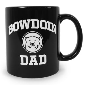 Black coffee mug with white imprint of BOWDOIN arched over a polar bear medallion over the word DAD.