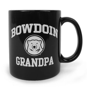Black coffee mug with white imprint of BOWDOIN arched over a polar bear medallion over the word GRANDPA.