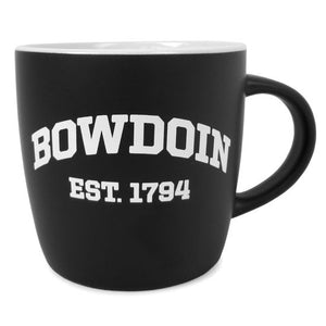 Matte black mug with white interior and slightly tapered shape. Arched BOWDOIN over EST. 1794 imprint in white.