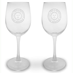 Pair of clear stemmed wine glasses with engraved Bowdoin College seal on each