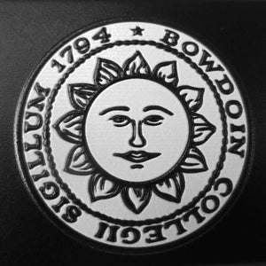 Closeup showing raised Bowdoin sun seal imprint.