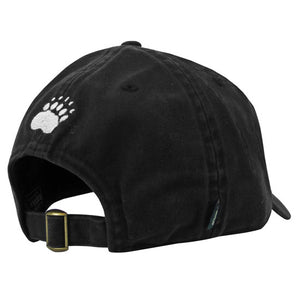 Back view of black ball cap showing brass buckle on self-closure and white embroidered paw print over opening.