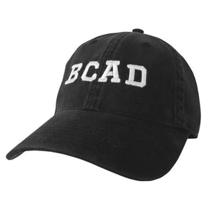 Black ball cap with white embroidered BCAD on front.
