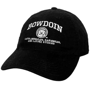 Black ball cap with white embroidered BOWDOIN arched over a mascot medallion over white text Latin American, Caribbean, and Latinx Studies 