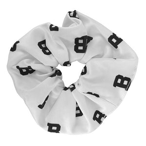 White Bowdoin scrunchie decorated with all-over print of Bowdoin Bs.