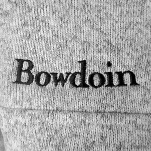 Closeup of black Bowdoin embroidery on chest.