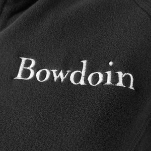 Closeup showing detail of white Bowdoin wordmark embroidery on black fleece.