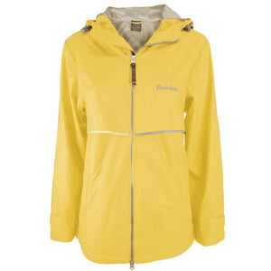 Women's butter yellow raincoat with silver reflective trim and Bowdoin imprint on left chest.