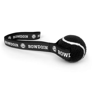 Black tennis ball dog tow with black nylon strap with repeating BOWDOIN and mascot medallion decoration.